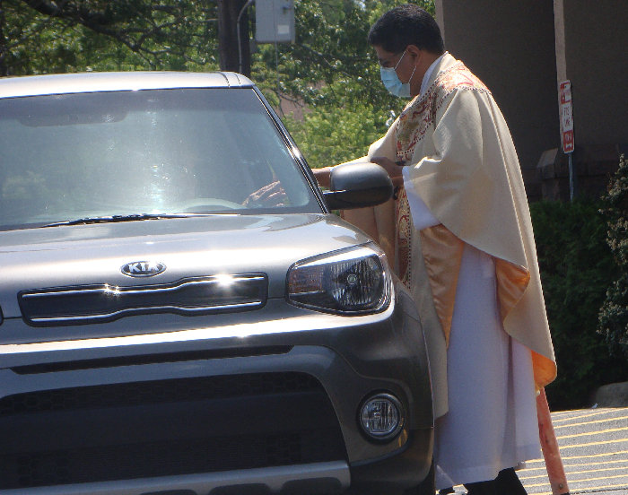 Fr. Nohe distributing the Host On Memorial Day Weekend
